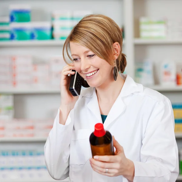 Pharmacist Holding Medicine Bottle While On Call In Pharmacy — Stock Photo, Image