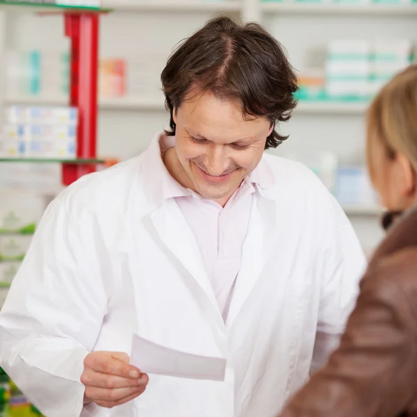 Pharmacist reading prescription — Stock Photo, Image