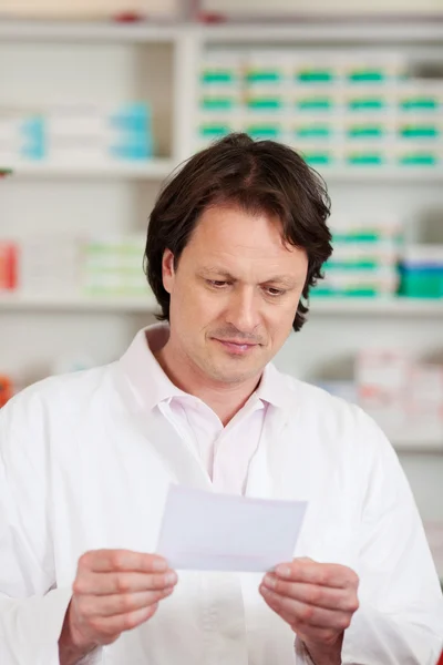 Pharmacist Reading Prescription Paper — Stockfoto