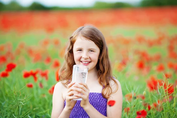 Smiling girl with mineral water — Stock Photo, Image