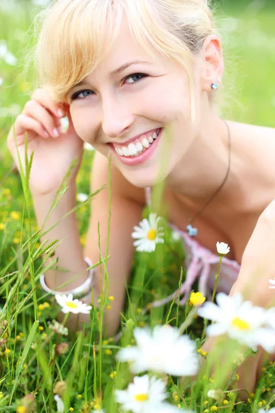 Bella donna sorridente tra i fiori primaverili — Foto Stock