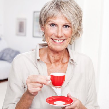 Portrait of a senior lady enjoying espresso clipart