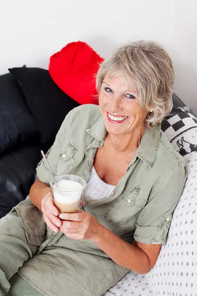 Smiling senior woman drinking cappuccino — Stock Photo, Image