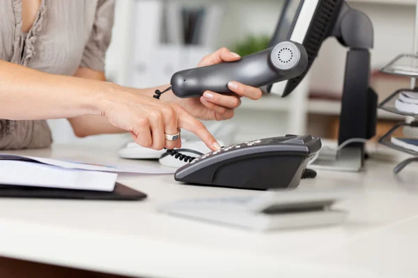 Businesswoman Pressing Number Button At Desk — Stock Photo, Image