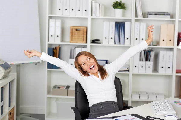 Excited Businesswoman With Arms Raised At Desk — Stock Photo, Image