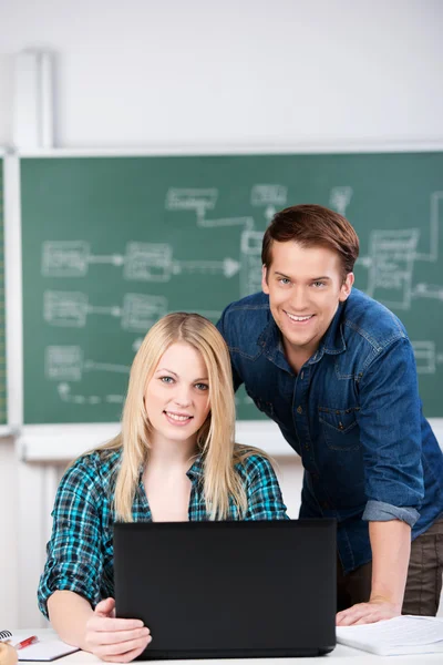 Confident Students With Laptop At Desk — Stock Photo, Image