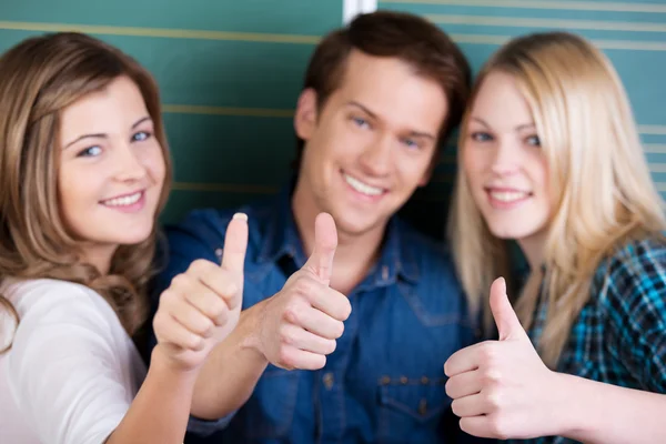 Male And Female Students Gesturing Thumbs Up — Stock Photo, Image