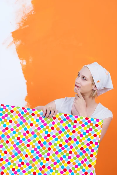 Woman thinking about new wallpaper — Stock Photo, Image