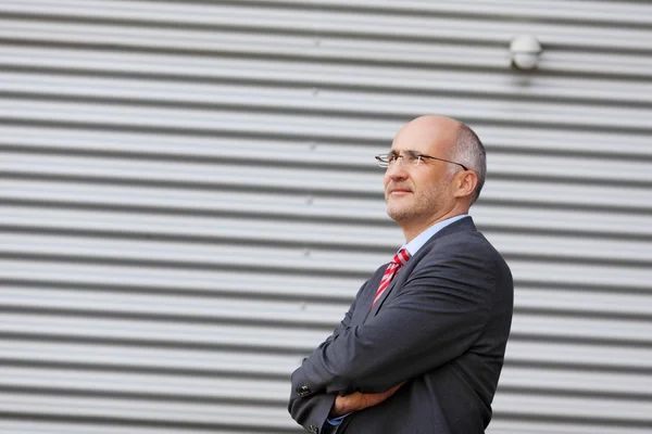 Businessman Looking Away Against Shutter — Stock Photo, Image