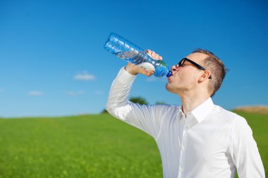 Man drinking bottled water clipart