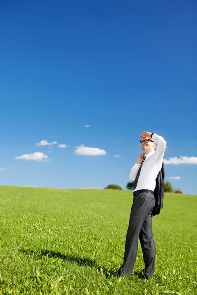 Businessman scanning the skies — Stock Photo, Image