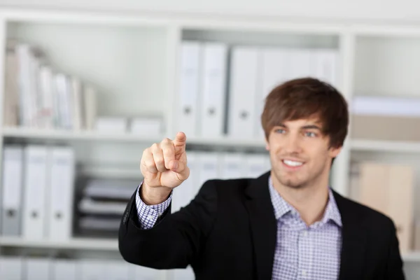 Businessman Pointing At Invisible Screen In Office — Stock Photo, Image