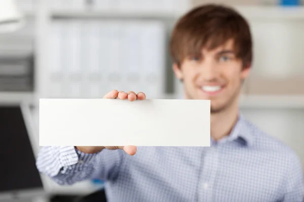 Empresário segurando um livro branco — Fotografia de Stock