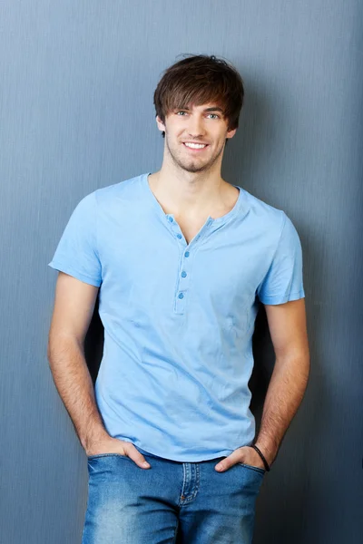 Man With Hands In Pocket Standing Against Blue Wall — Stock Photo, Image