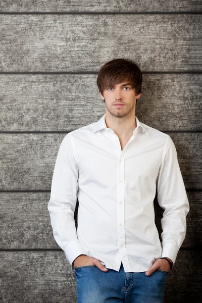 Businessman With Hands In Pockets Standing Against Wooden Wall — Stock Photo, Image