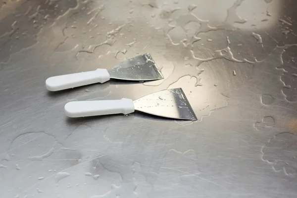 Two stainless steel spatulas in a cheesemaking — Stock Photo, Image