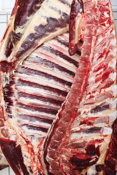 Half of a cow carcass hanging on a butcher — Stock Photo, Image