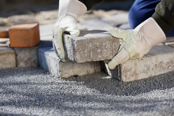 Construction worker paving the brick road — Stock Image Construction worker paving the brick road Stock Image