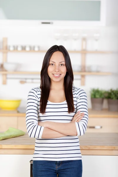 Self-confident young woman standing in the kitchen Stock Photo