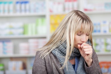 Female Customer Coughing In Pharmacy clipart