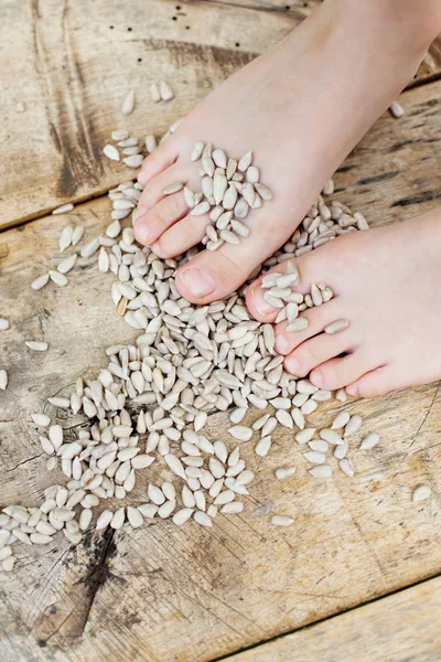 Kinderfüße auf einem Holztisch — Stockfoto