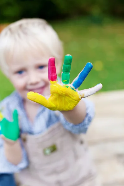 Playful child showing colorful hand — Stock Photo, Image