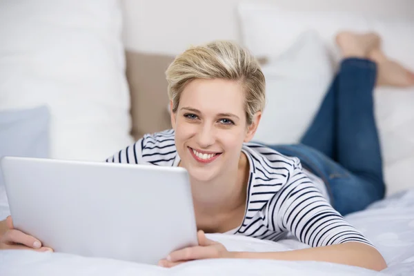 Woman Holding Digital Tablet While Lying On Bed — Stock Photo, Image