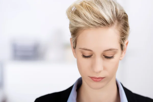 Businesswoman Looking Down In Office — Stock Photo, Image