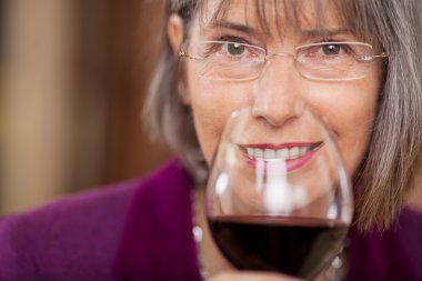 Female Customer Drinking Red Wine In Restaurant clipart