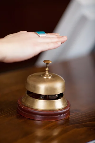 Clients Hand Over Bell At Hotel Reception — Stock Photo, Image