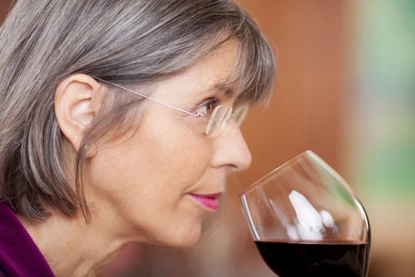 Mulher bebendo vinho tinto no restaurante — Fotografia de Stock