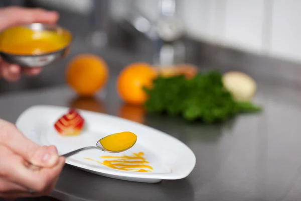 Руки шеф-повара гарнир тарелка на кухне прилавок — стоковое фото