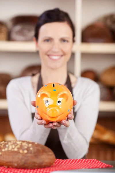 Woman with bread and piggy bank — Stock Photo, Image