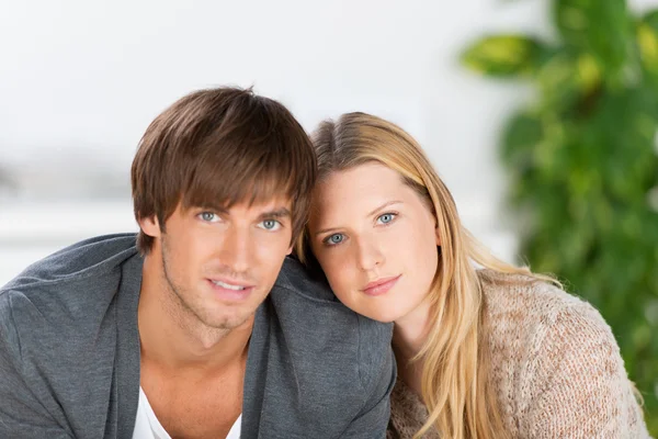 Young couple sitting nearby — Stock Photo, Image