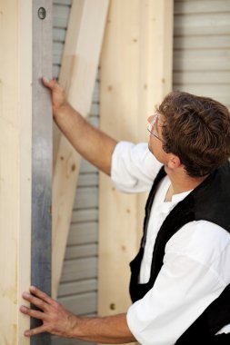 Carpenter measures with a water level clipart