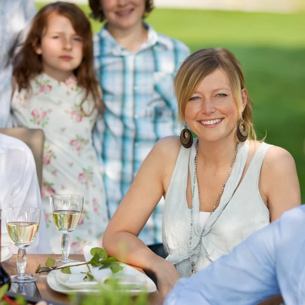 Mladá žena s rodinou v trávníku — Stock fotografie