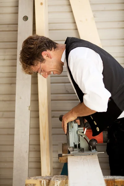 Carpenter with a saw Stock Picture