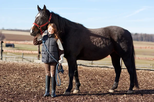 Portrait of a pretty young girl with her horse — Stock Photo, Image