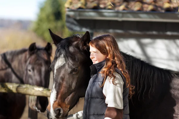 Pretty girl leading her horse — Stock Photo, Image