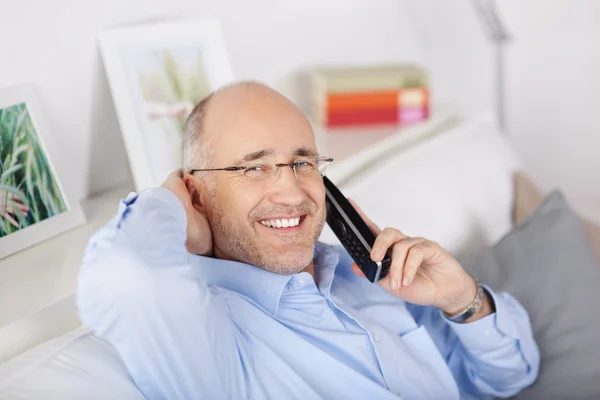 Gelukkig man met telefoon thuis — Stockfoto