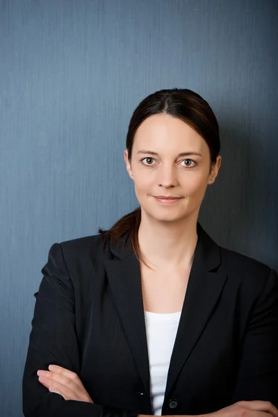 Serious Businesswoman Against Blue Wall — Stock Photo, Image