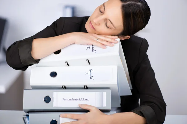 Woman Leaning On Stack Of Binders — Stock Photo, Image