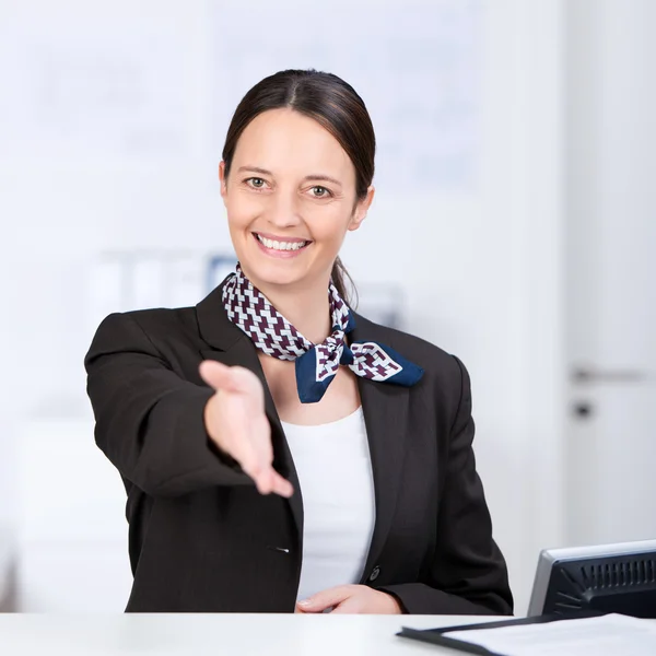 Receptionist Offering Handshake At Counter — Stock Photo, Image