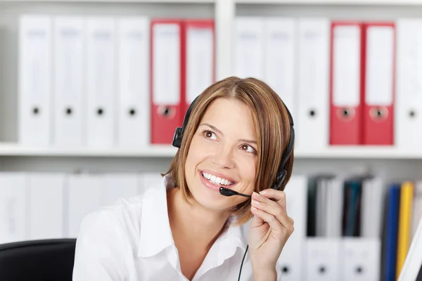 Happy businesswoman talking on headset — Stock Photo, Image
