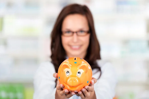 Pharmacist with piggybank — Stock Photo, Image