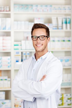 Confident Male Pharmacist At Drugstore clipart