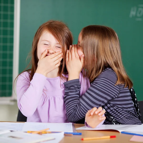 Laughing little girls sharing secrets — Stock Photo, Image