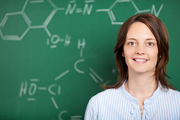 Teacher in front of a blackboard — Stock Photo, Image