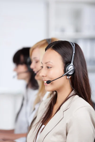 Asian woman using headset in office — Stock Photo, Image
