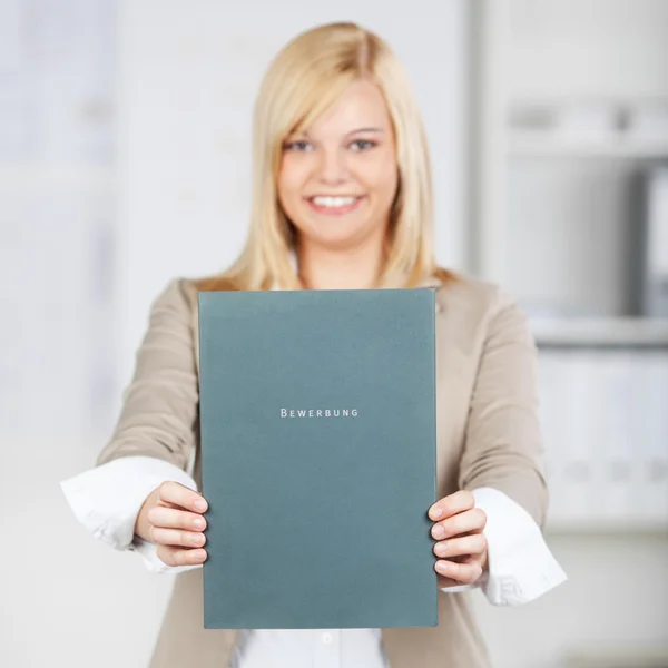 Young Businesswoman Holding Application File In Office — Stock Photo, Image